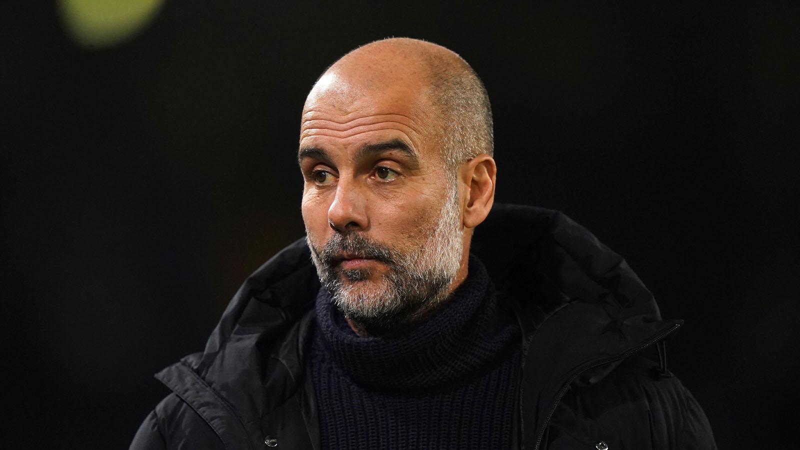 Manchester City manager Pep Guardiola watches warm up prior to the Premier League match at Elland Road